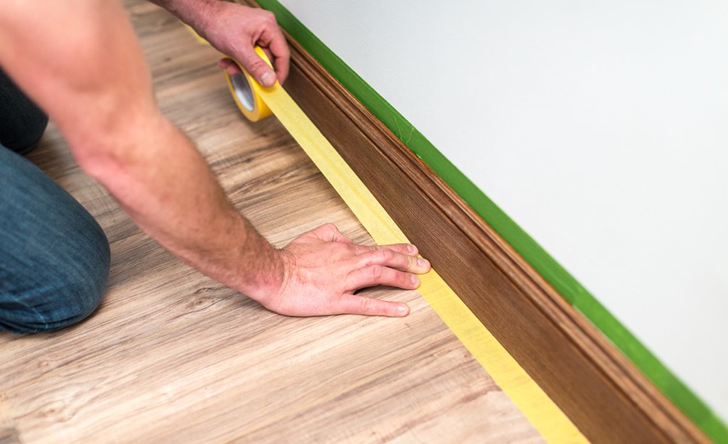 Professional painter finishing trim - cost to paint a home accurately includes trim work