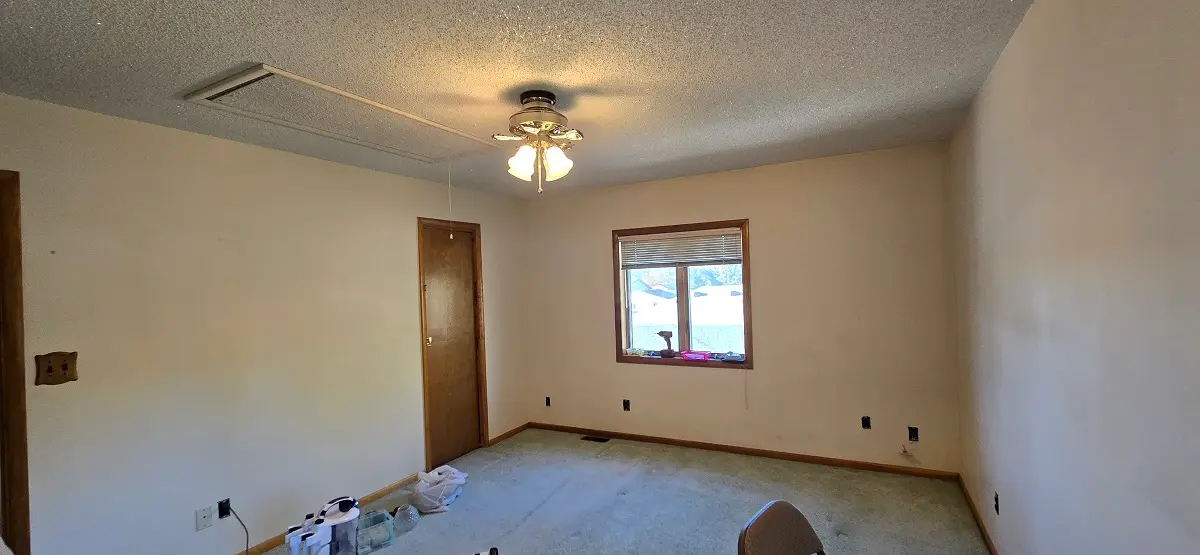 Substandard contractor-grade drywall finish in a Woodhaven Michigan room before full repair and refinishing