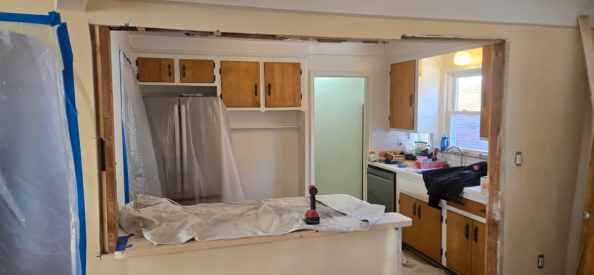 Plaster edge damage and exposed framing at wall opening before repair in Ecorse MI