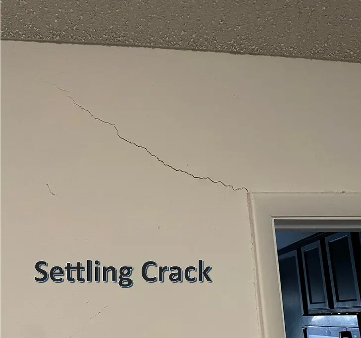 Drywall and plaster settling crack near a doorway in a Grosse Ile home