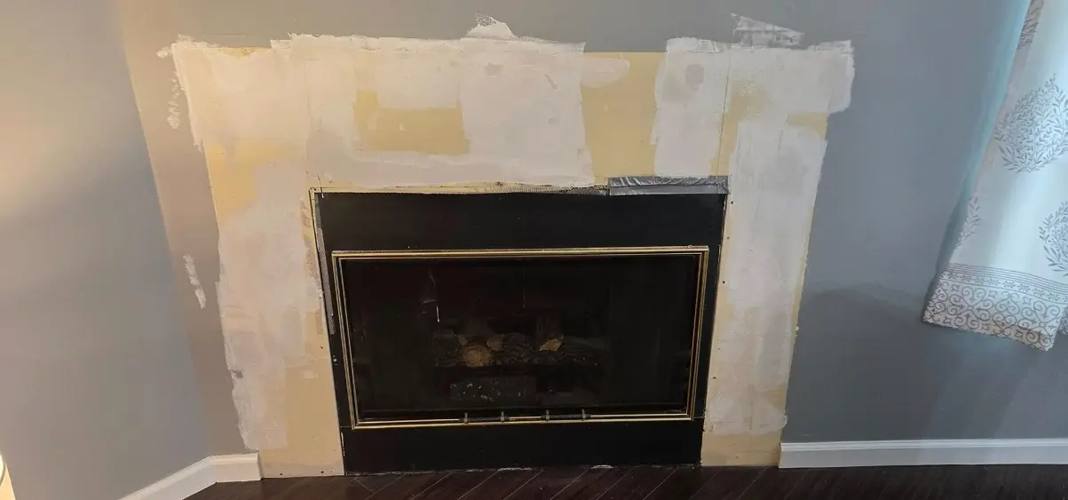 Fireplace wall before painting and repair in Southgate MI