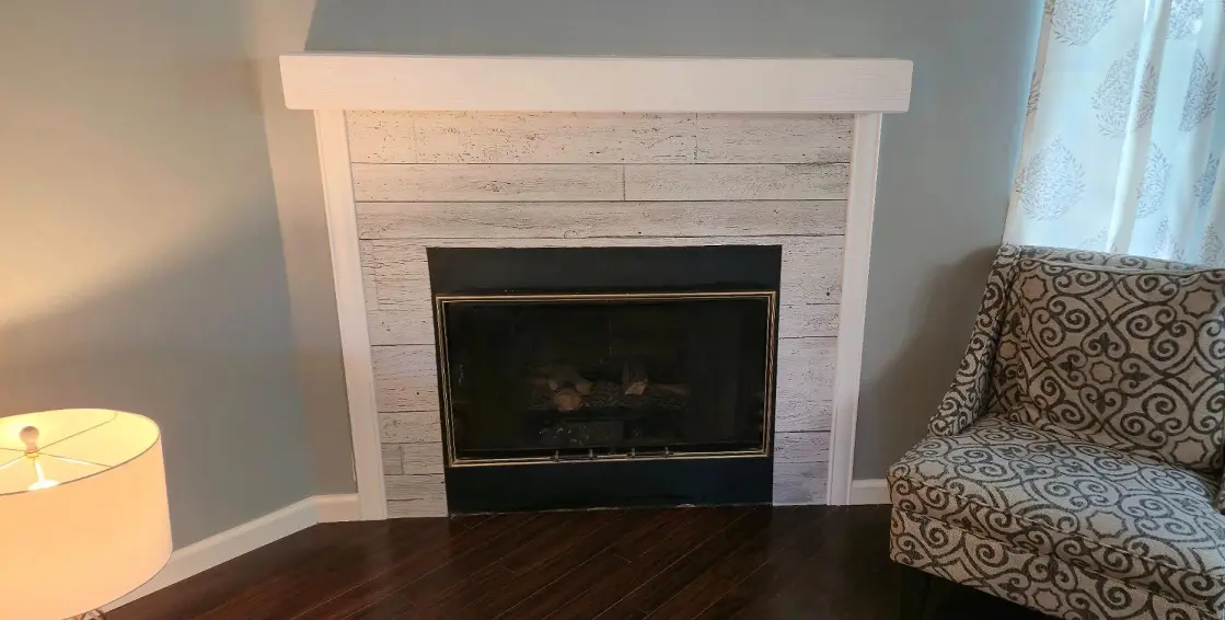 Fireplace wall after painting and decorative panel update in Southgate MI