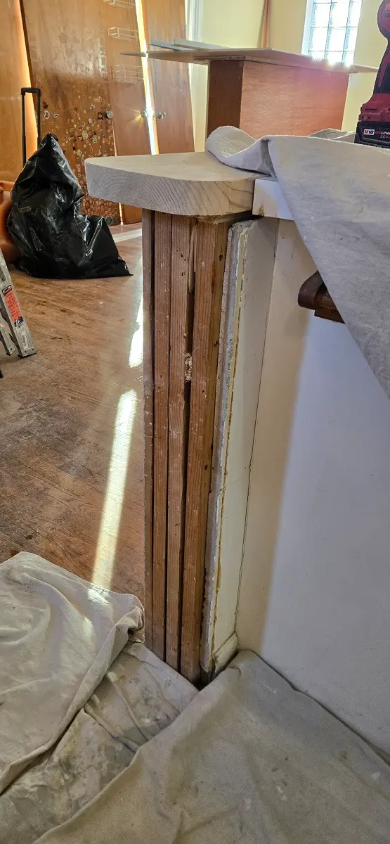 Plaster removal exposing wood lath during wall repair in Ecorse MI