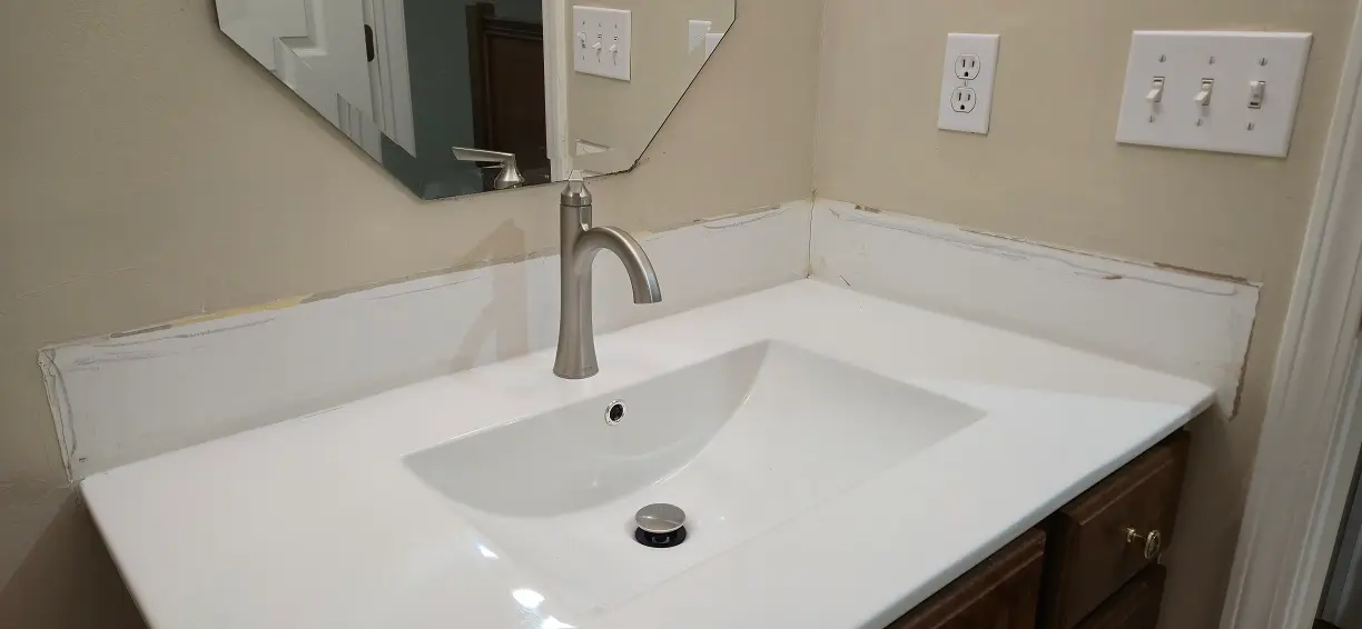 Bathroom wall damage before painting after vanity replacement in Lincoln Park MI